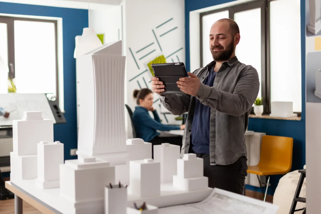 Bearded architect using a tablet to review a 3D building model